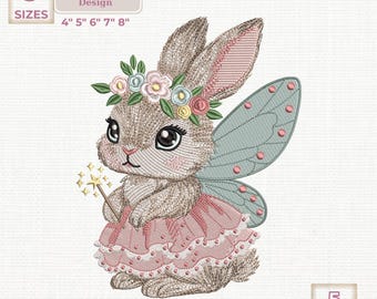 May include: An embroidered design of a fairy bunny with a floral crown, pink dress, and blue wings. The design includes a magic wand and is available in 5 sizes: 4", 5", 6", 7", and 8". The design is labeled as an embroidery design.