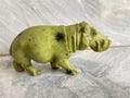 walking hippo sculpture product logo