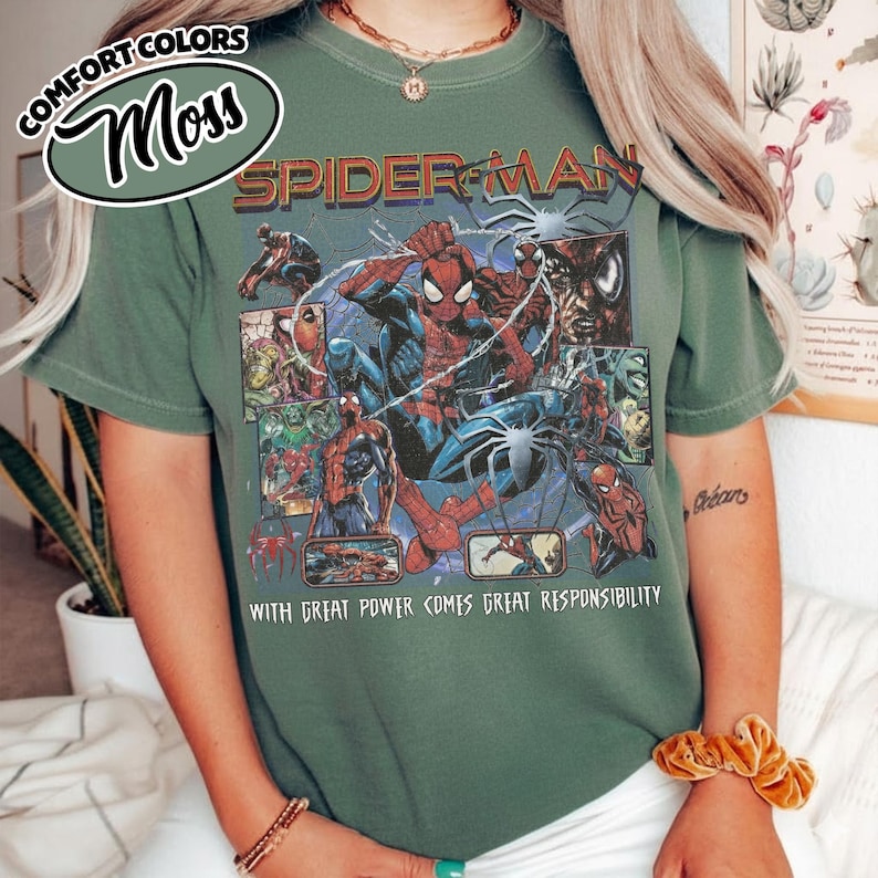 K&ouml;nnte beinhalten: Moosgr&uuml;nes T-Shirt mit einem Spider-Man-Motiv. Das Design enth&auml;lt die Worte "Spider-Man" und den Satz "With great power comes great responsibility." Das Shirt hat kurze &Auml;rmel und einen Rundhalsausschnitt.