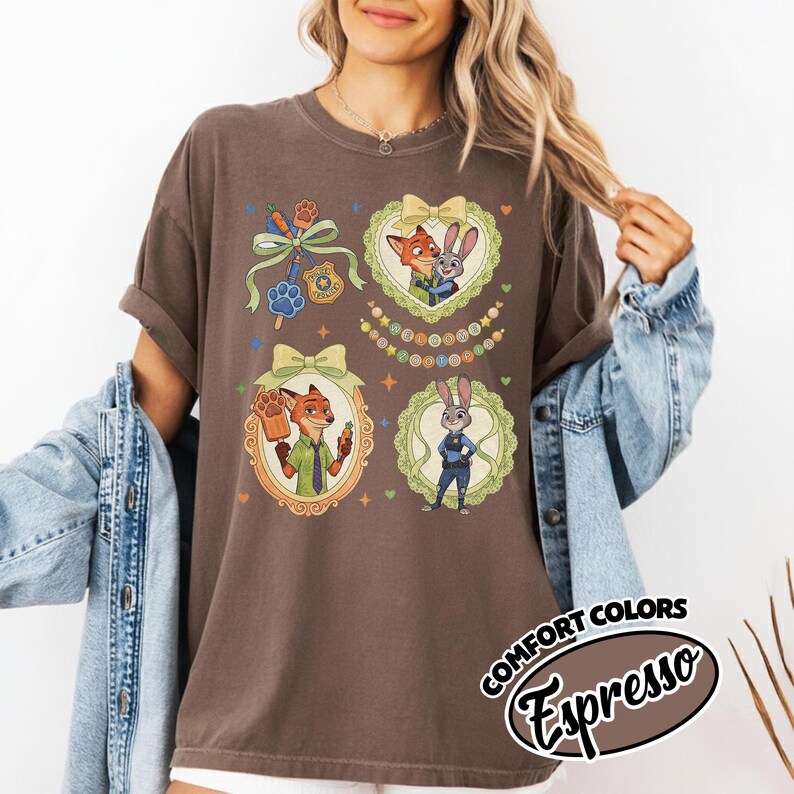 May include: A dark brown short-sleeve t-shirt featuring a graphic print of two animated animal characters in ornate frames, a police badge, and a carrot-shaped popsicle. The text COMFORT COLORS Espresso is printed in a black oval at the bottom right.