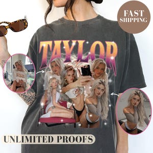 May include: Dark gray t-shirt featuring a graphic of a woman with the name "TAYLOR" in a retro font. The shirt includes additional images of the woman and the text "UNLIMITED PROOFS".