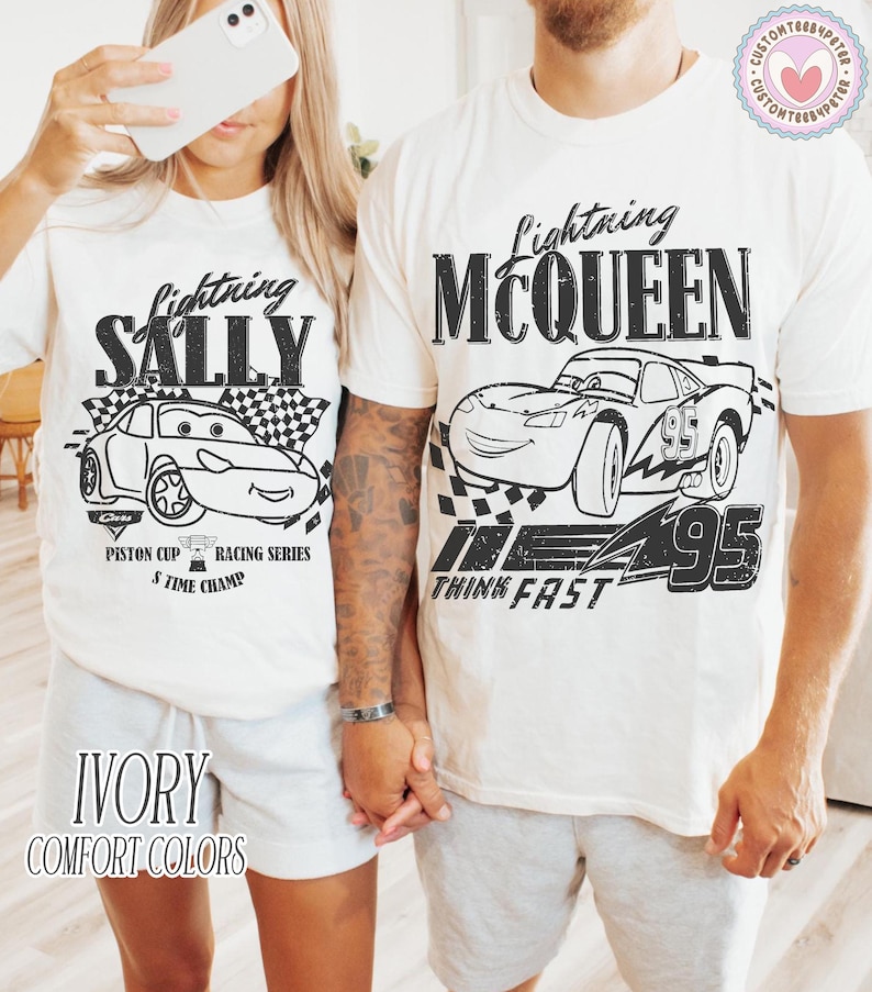 May include: Ivory t-shirts with Lightning McQueen and Sally Carrera designs from the Cars film. The black graphics include the characters, racing flags, and text. The text reads "Piston Cup Racing Series" and "Think Fast".