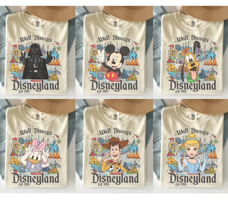 May include: Cream-colored t-shirts featuring various Disney characters and the Disneyland logo. Characters include Darth Vader, Mickey Mouse, Pluto, Daisy Duck, Woody, and Cinderella. Each shirt has the text "Walt Disney's Disneyland Est 1955".