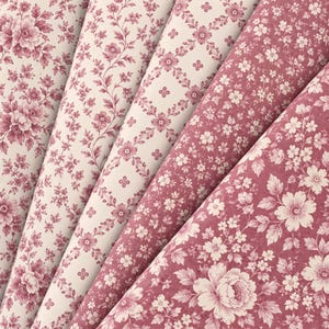 May include: Five rolls of fabric or paper featuring various floral patterns in shades of dusty rose and cream. The designs include dense bouquets, delicate trailing vines, a geometric diamond lattice with small flowers, and scattered blossoms.