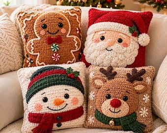 May include: Four square crochet pillows featuring holiday characters: a brown gingerbread person, a red Santa Claus with a white beard, a white snowman with a green hat and red scarf, and a brown reindeer with a green scarf.