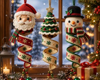 May include: Three hanging crochet ornaments featuring a Santa Claus, a Christmas tree, and a snowman. Each figure has a long, spiraling ribbon tail decorated with snowflake patterns and two small, shiny red and green spherical bells at the bottom.