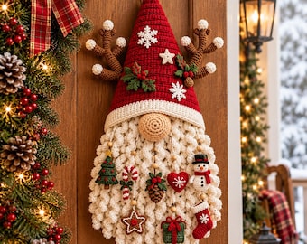 May include: A crocheted Christmas gnome wall hanging with a red pointed hat, white snowflake accents, and brown reindeer antlers. The gnome has a beige nose and a long white beard decorated with small hanging ornaments including a tree, candy cane, pinecone, heart, snowman, star, gift, and stocking.