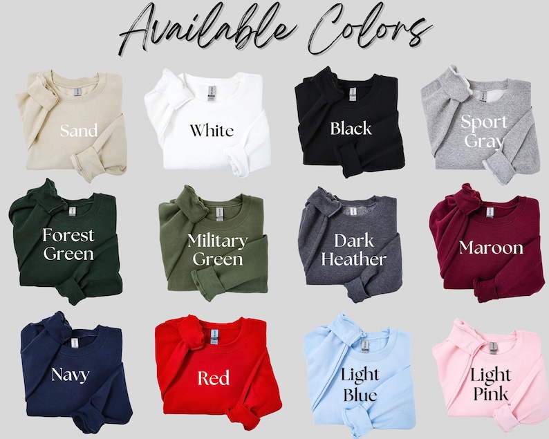 Op de afbeelding: Een selectie van crewneck sweatshirts in verschillende kleuren, waaronder zand, wit, zwart, sportgrijs, bosgroen, legergroen, donkergrijs, bordeauxrood, marineblauw, rood, lichtblauw en lichtroze. De tekst "Available Colors" staat bovenaan.