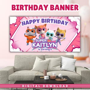 May include: A pink birthday banner with the text "BIRTHDAY BANNER" at the top. The banner features the words "HAPPY BIRTHDAY" and "SUPER KAITLYN is turning 5" with cartoon cat characters. The banner is displayed above a gray couch.