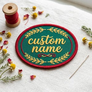 May include: A set of three ceramic mugs with a speckled, cream-colored glaze. Each mug features a different hand-painted floral design in shades of blue, green, and yellow. The mugs have a simple, rounded shape and a comfortable handle.