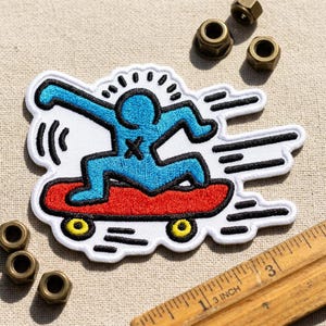 Retro Blue Figure Skateboarder Embroidered Patch - Pop Art Style Iron On Applique for Jackets - Abstract Humanoid Skater Patch