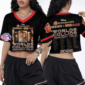 May include: Black crop top with red trim featuring the text "Descendants Zombies + Camp Rock Worlds Collide Concert Tour" and a group photo. The back of the shirt also has text and a list of cities. The year 2026 is printed on the bottom.