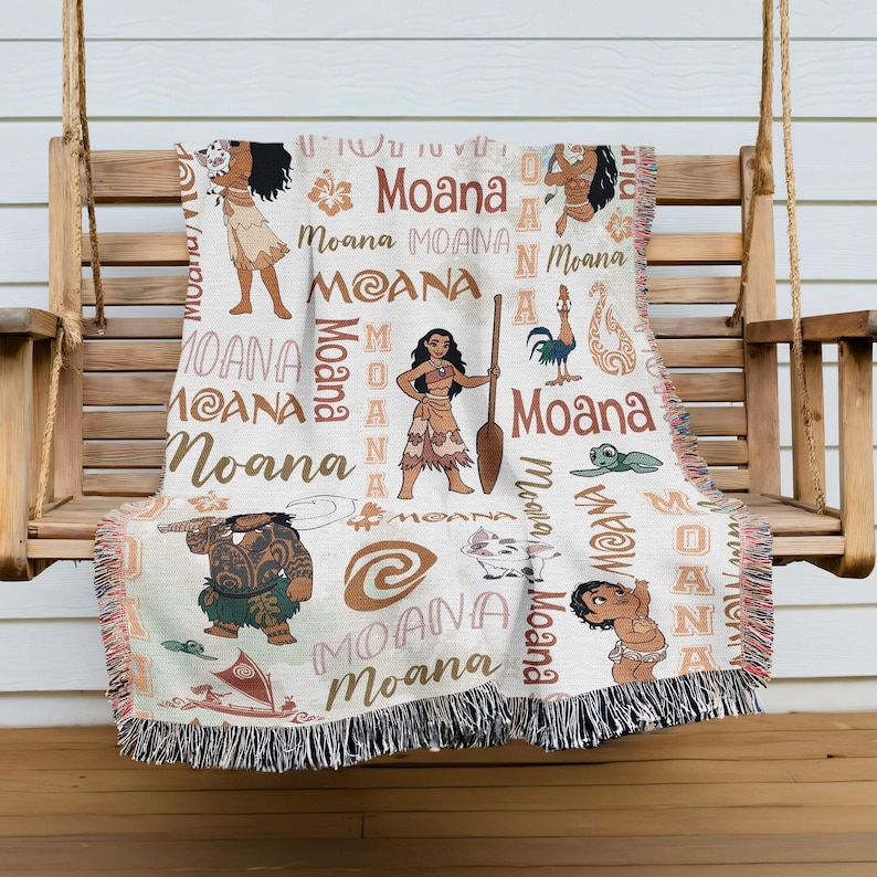 a woven blanket with various Moana characters and designs, including Moana, Moana, Moana, and Moana, printed on it.