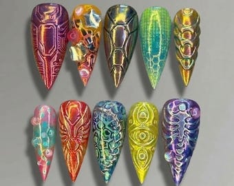 May include: A set of ten long, pointed artificial nails with intricate designs. The nails feature a variety of colors, including iridescent, metallic, and holographic finishes. Designs include geometric patterns, textures, and embellishments, creating a futuristic and artistic aesthetic.