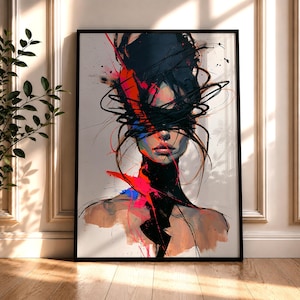 May include: A framed wall art print featuring an abstract portrait of a person with their eyes obscured by chaotic black brushstrokes. The composition includes vibrant splashes of red and blue paint against a neutral background, creating a high-contrast visual effect.