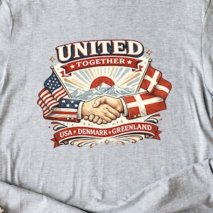 May include: A light gray t-shirt featuring a graphic with the words "UNITED TOGETHER" above a handshake illustration. The flags of the USA and Denmark are on either side of the handshake, with the text "USA DENMARK GREENLAND" below.