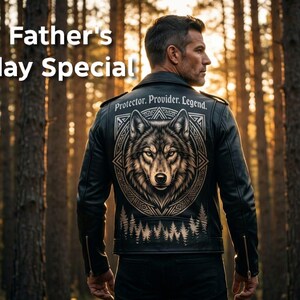 May include: A black leather jacket featuring a large graphic of a wolf head centered on the back, surrounded by geometric patterns and a forest silhouette. The text "Protector. Provider. Legend." is printed above the wolf, and "Father's day Special" appears in the upper left corner.