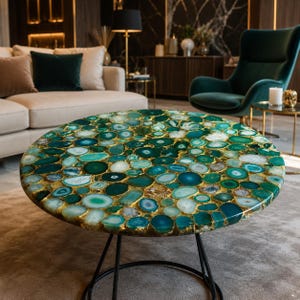 May include: A round coffee table featuring a tabletop composed of numerous polished green and teal agate slices embedded in a gold-toned resin matrix, supported by a thin black metal frame with a circular base and four slender legs.
