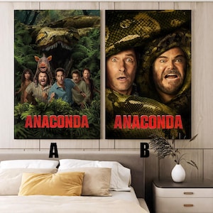 May include: Two framed movie posters for the film "Anaconda." Poster A shows a group of people in a jungle setting with a large snake and the film's title in red. Poster B features two actors with a snake and the film's title.