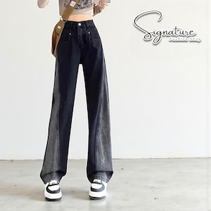May include: Wide-leg black and grey denim jeans. The jeans have a two-tone design, with a darker shade on the front and a lighter grey on the sides. They are high-waisted and feature a classic five-pocket design.
