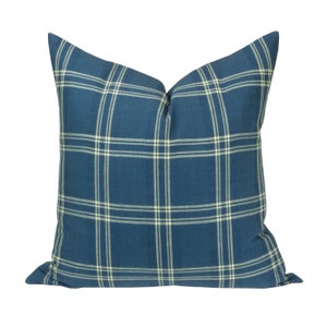 May include: A blue and white plaid throw pillow with a square pattern.