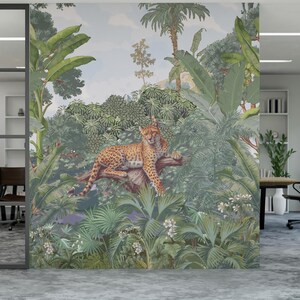 May include: A large mural featuring a jungle scene with lush green foliage, palm trees, and a leopard resting on a branch. The mural is in an office setting with glass walls and a concrete floor.