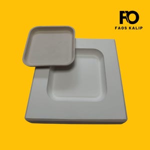 May include: A light gray square tray and a larger square container with a recessed square area. The items are on a yellow background. The text "FO FAOS KALIP" is in black in the upper right corner.
