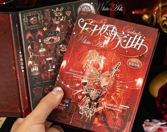 May include: A rectangular sticker book titled White Ash Prelude with a deep red cover featuring a skeletal ribcage, a dagger, a wine glass, and a birdcage illustration. The cover includes white text, a pearl necklace graphic, and a circular 27P label.