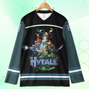 May include: Black and teal hockey jersey with a V-neck and long sleeves. The jersey features a graphic of a group of characters and the word "Hytale" in blue. White stripes accent the sleeves and bottom hem.