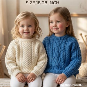 May include: Digital knitting patterns for 18-28 inch size. Two children sit on a wooden bench wearing long-sleeved sweaters. One child wears a cream-colored cable knit sweater, and the other wears a blue cable knit sweater. Both wear white pants.