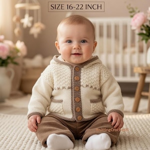 May include: A baby wearing a cream-colored hooded cardigan with brown trim and wooden buttons, paired with brown pants. The image features the text KNITTING PATTERNS FOR BABIES SIZE 16-22 INCH. The baby is sitting on a white textured rug.