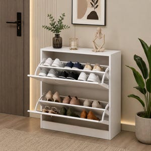 May include: A white shoe cabinet with two tilting doors, each revealing a row of shoes. The cabinet is filled with various shoes in colours like white, black, and tan. A plant and decorative items sit on top.