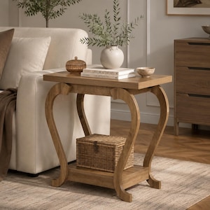May include: A light brown wooden end table with a rectangular top and a lower shelf. The table features four curved legs that extend outwards. A woven wicker box sits on the lower shelf, while a white vase, two stacked books, and a bowl sit on top.