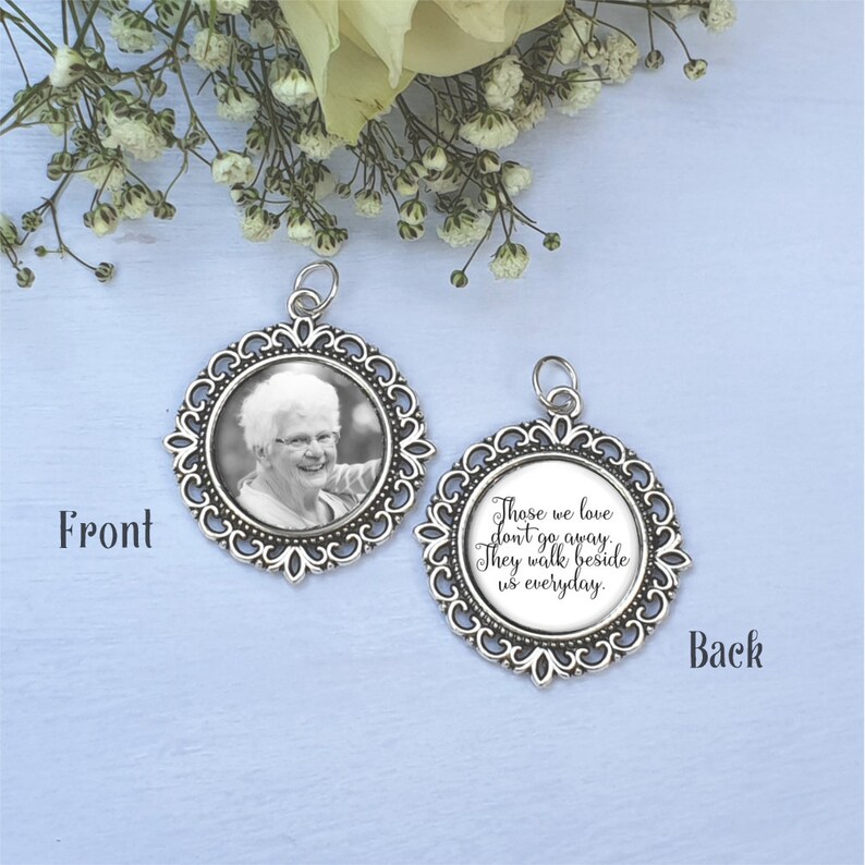 May include: Silver memorial charm with a photo on the front and a quote on the back. The quote reads "Those we love don't go away. They walk beside us everyday."