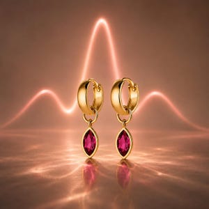 May include: A pair of gold hoop earrings featuring dangling marquise-cut fuchsia gemstones. Each earring consists of a polished gold hoop with a small jump ring connecting to a faceted, pointed oval-shaped pink stone set in a gold frame.