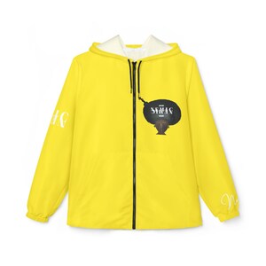 May include: A bright yellow zip-up hooded jacket featuring a black front zipper and a white interior lining. The chest displays a graphic of a person with an afro hairstyle and the text "NEMAC" in white. The sleeves feature white text details.