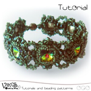 May include: A green beaded bracelet with a crystal center piece. The bracelet is made with dark green beads and has a silver clasp. The bracelet is called "Tutorial -  Apatite"