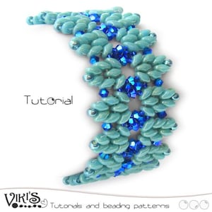 May include: A turquoise and blue beaded bracelet with a geometric pattern. The bracelet is made with small seed beads and features a repeating design of interlocking triangles. The bracelet is called "Wings" and is a beading tutorial.