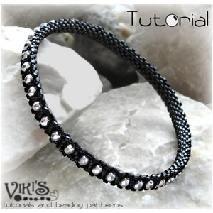 May include: Black beaded bangle bracelet with silver-colored accents. The bracelet is labeled "Boho Bangle Tutorial" and features the text "Viki's Tutorials and beading patterns."