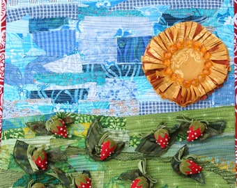 May include: A quilted wall hanging with a patchwork design featuring a blue sky, a yellow sun, and red strawberries on a green field.