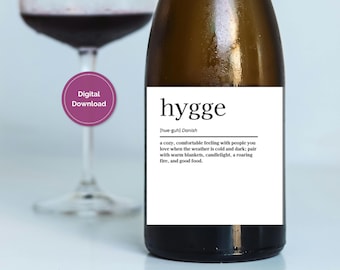 May include: A brown wine bottle with a white label featuring the word "hygge" and its definition. A glass of red wine is in the background. A purple circle with "Digital Download" is in the upper left.