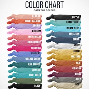 May include: A color chart displaying a variety of comfort colors. The chart includes swatches of various hues, such as Peachy, Bright Salmon, Orchid, Blossom, Watermelon, Crunchberry, Heliconia, Flo Blue, Washed Denim, Blue Spruce, Seafoam, Light Green, Moss, and Black.