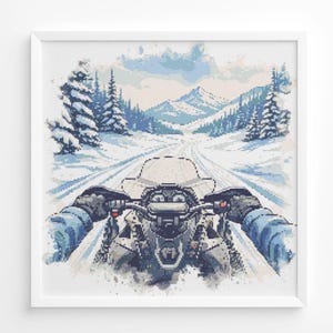 May include: A framed cross-stitch depicting a snowmobile ride through a snowy mountain landscape. The artwork features a first-person perspective, with the snowmobile in the foreground and snow-covered trees and mountains in the background. The color palette is primarily blues and whites.