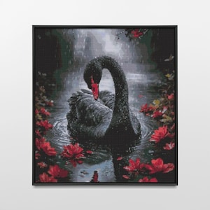 May include: A framed artwork depicts a black swan with a red beak, gracefully positioned in water. The swan is surrounded by red flowers, creating a striking contrast against the dark feathers and water. The artwork is framed in a black square frame.