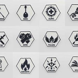 Peut inclure: Douze écussons hexagonaux brodés en noir et blanc. Chaque écusson présente une icône et un nom de classe, notamment Barbare, Barde, Clerc, Druide, Guerrier, Moine, Paladin, Rôdeur, Voleur, Sorcier, Occultiste et Magicien.