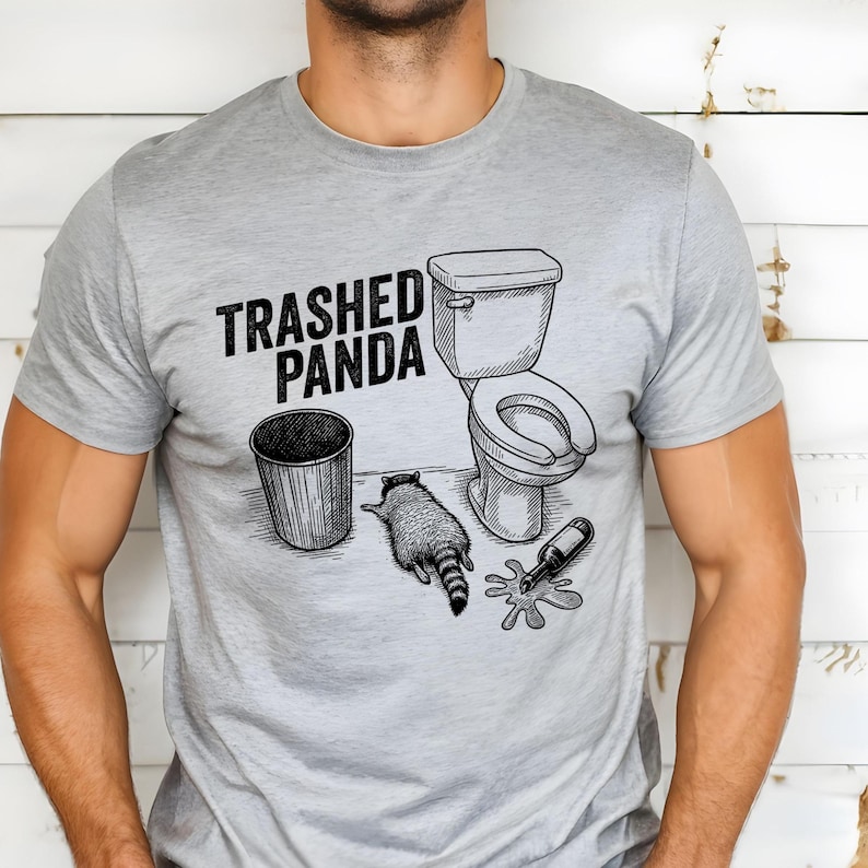 A line art illustration features a raccoon lying on its stomach on the floor, looking exhausted or passed out. Next to the animal is a spilled bottle with liquid pooling on the ground, a trash can, and a toilet. The text above reads TRASHED PANDA in bold, distressed letters.