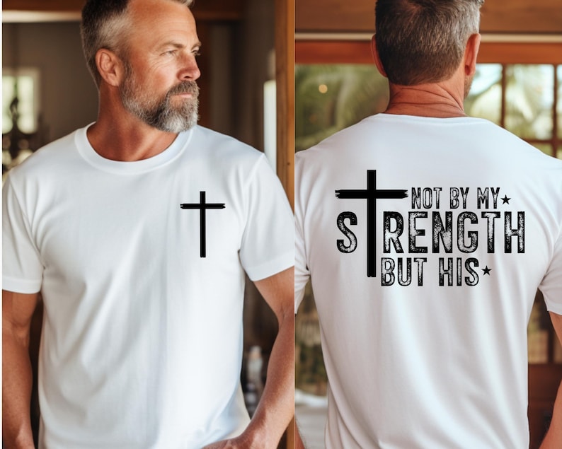 Men’s Christian tee featuring a small front cross and a large back design with a cross and the phrase “Not by my strength but His.” A clean faith-based style emphasizing strength through Christ.