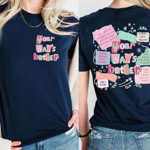 May include: Navy blue t-shirt with the text "Your Way's Better" in colorful bubble letters on the front and back. The back of the shirt features additional text and graphics in a similar style.