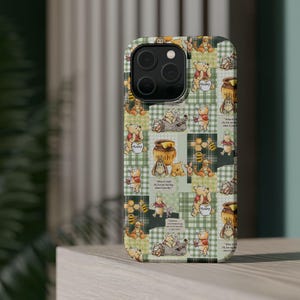 May include: A phone case featuring a patchwork design with Winnie the Pooh characters, honey pots, and bees on a green and white checkered background. The case has a glossy finish and a camera cutout.
