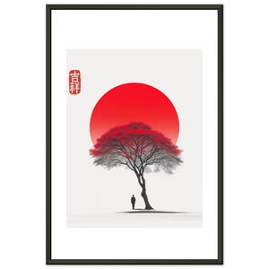 May include: Framed art print depicting a tree with red leaves in front of a red sun, with a small figure beneath. The artwork has a minimalist, Japanese-inspired design. The frame is black. The print includes Japanese text.